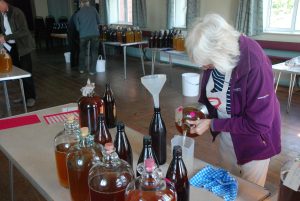 volunteer filling flagons at the cider trials